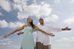 African couple with arms outstretched